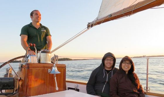 Couple sailing on Schooner Adirondack III for a sunset sail in Boston Harbor